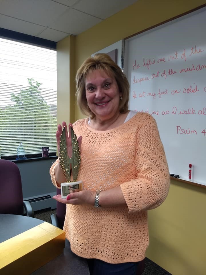 Karen holding the award